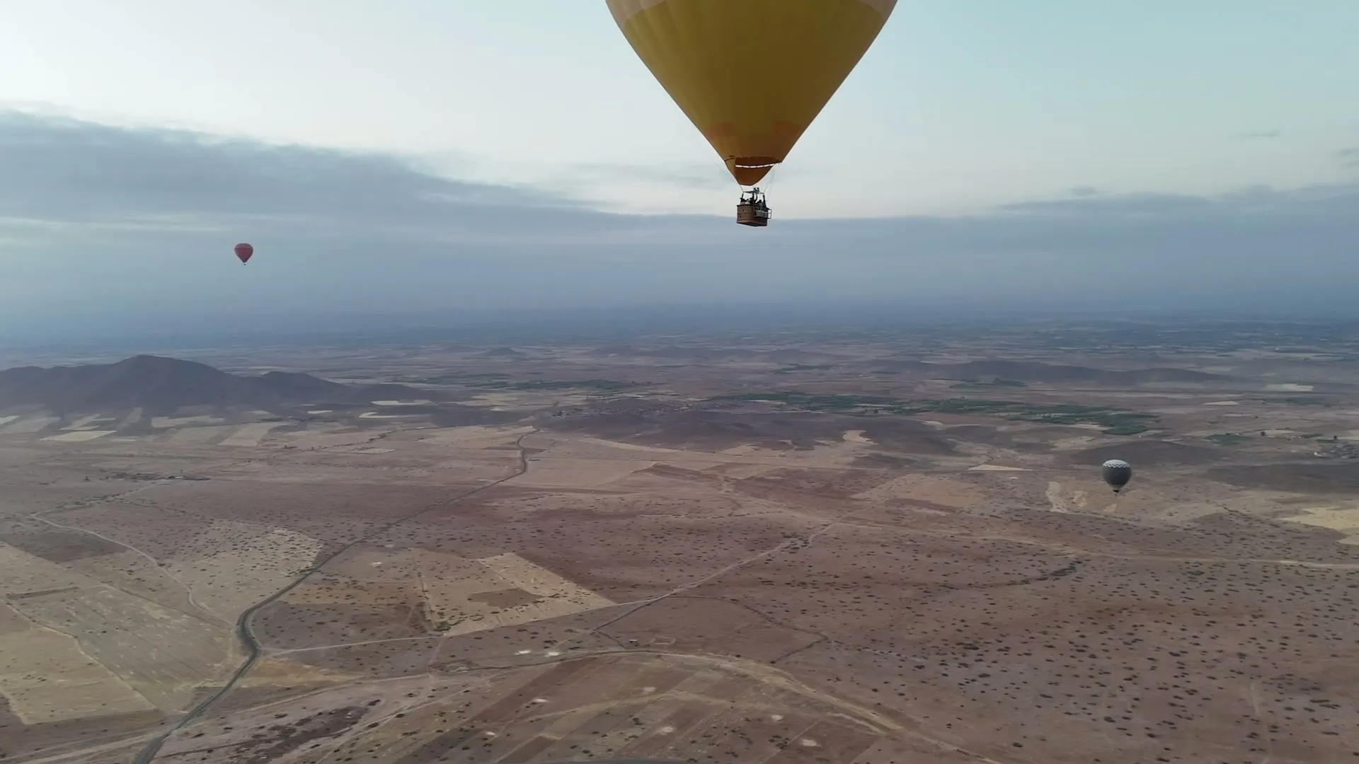 Aerial view of hot-air balloons above the plains outside Marrakech at sunrise