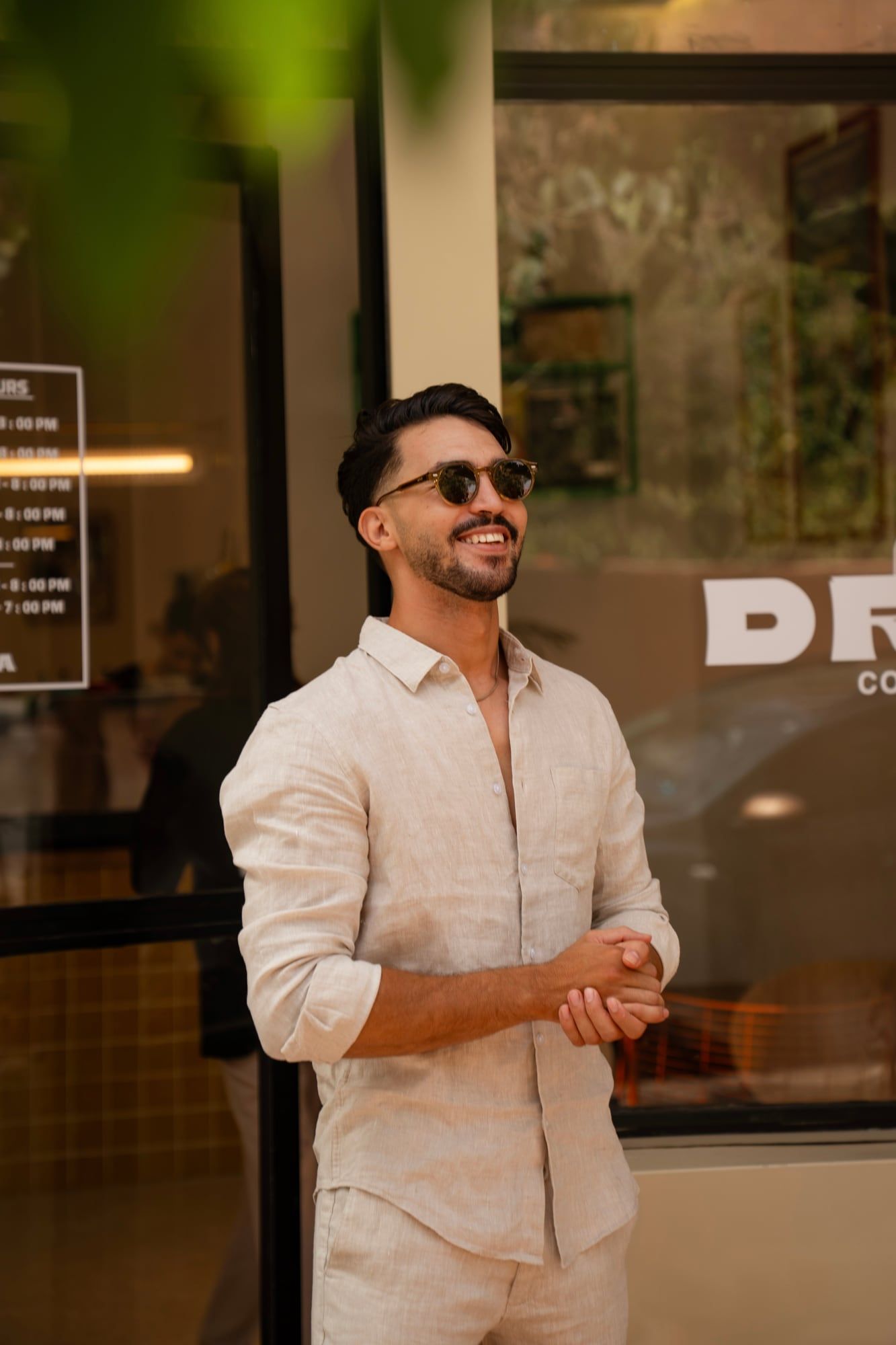 Man in linen wearing Azylis sunglasses outside a café in Marrakech