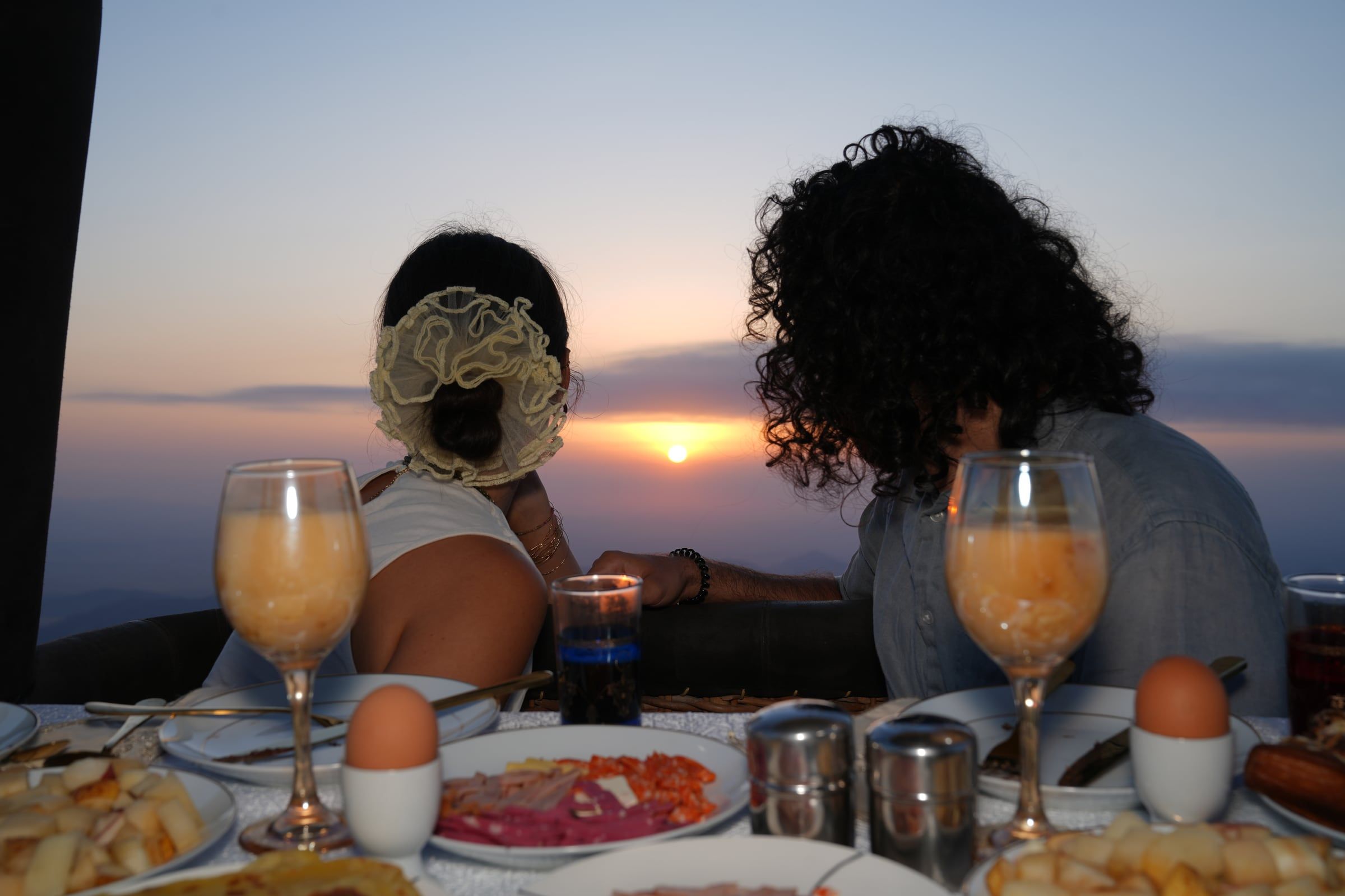 Couple watching the sunrise from a hot-air balloon over Marrakech