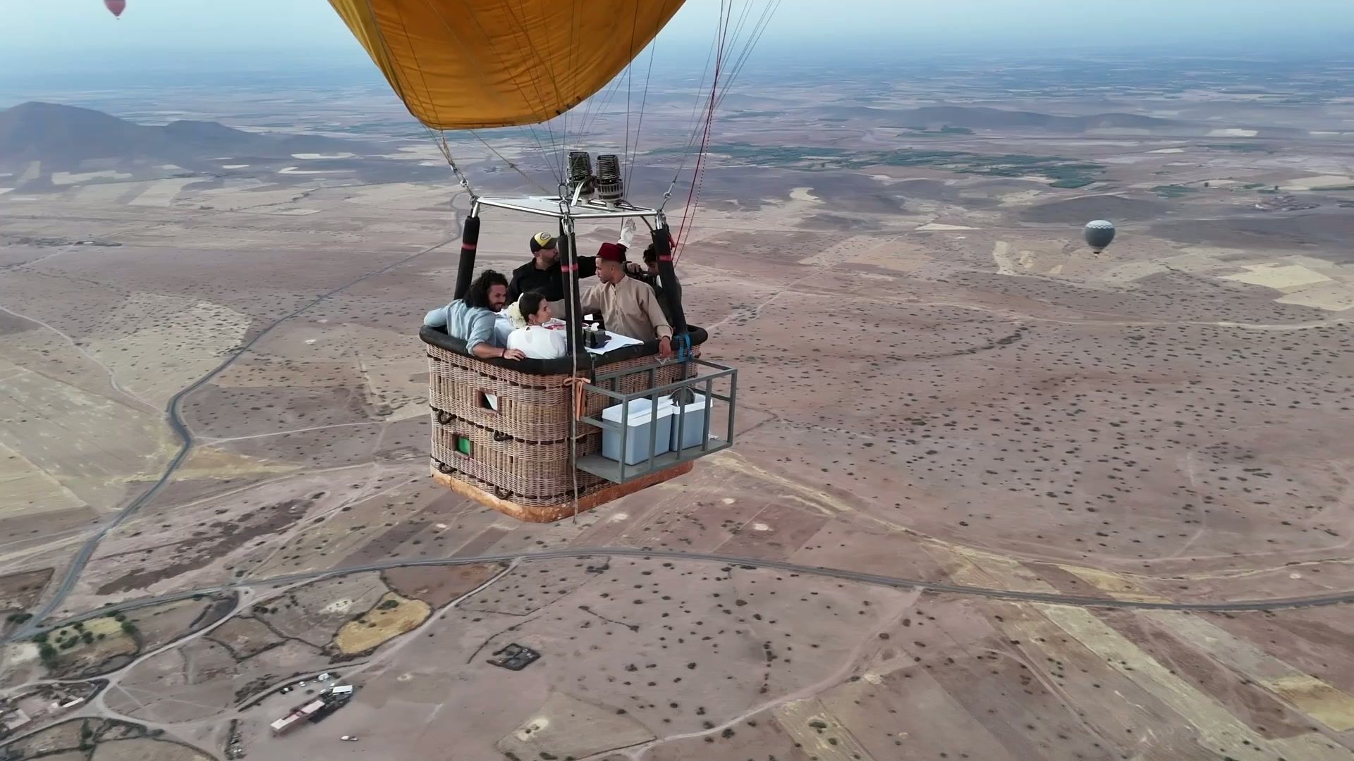 Drone shot of a hot-air balloon basket above the desert outside Marrakech