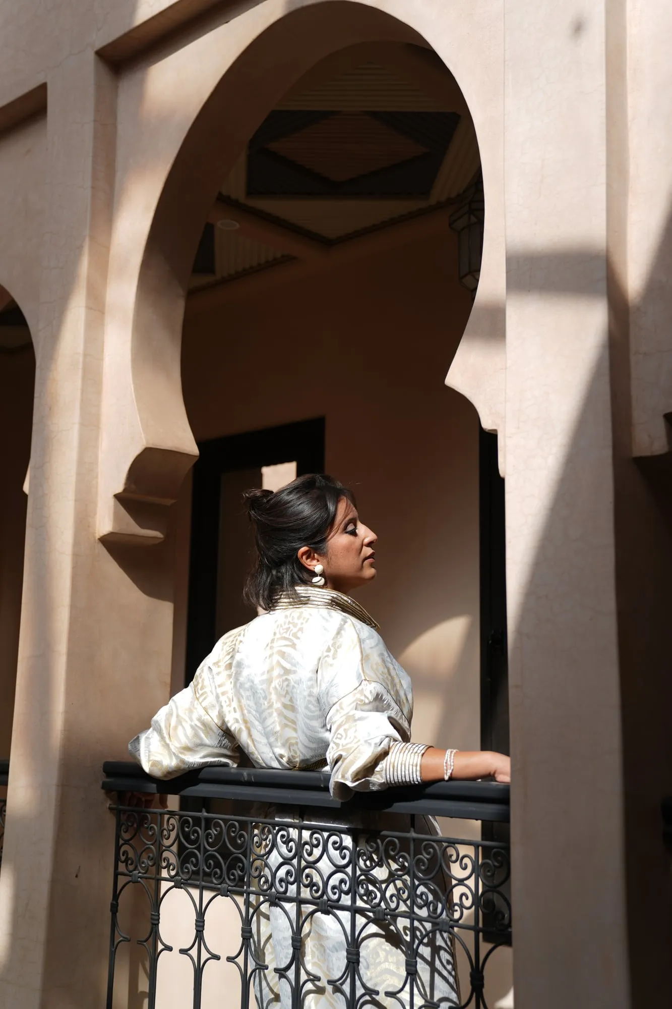 Fashion editorial under Moorish arches in a riad