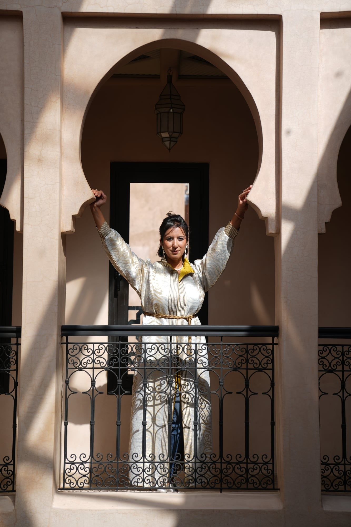 Model posing on a riad balcony for a fashion shoot