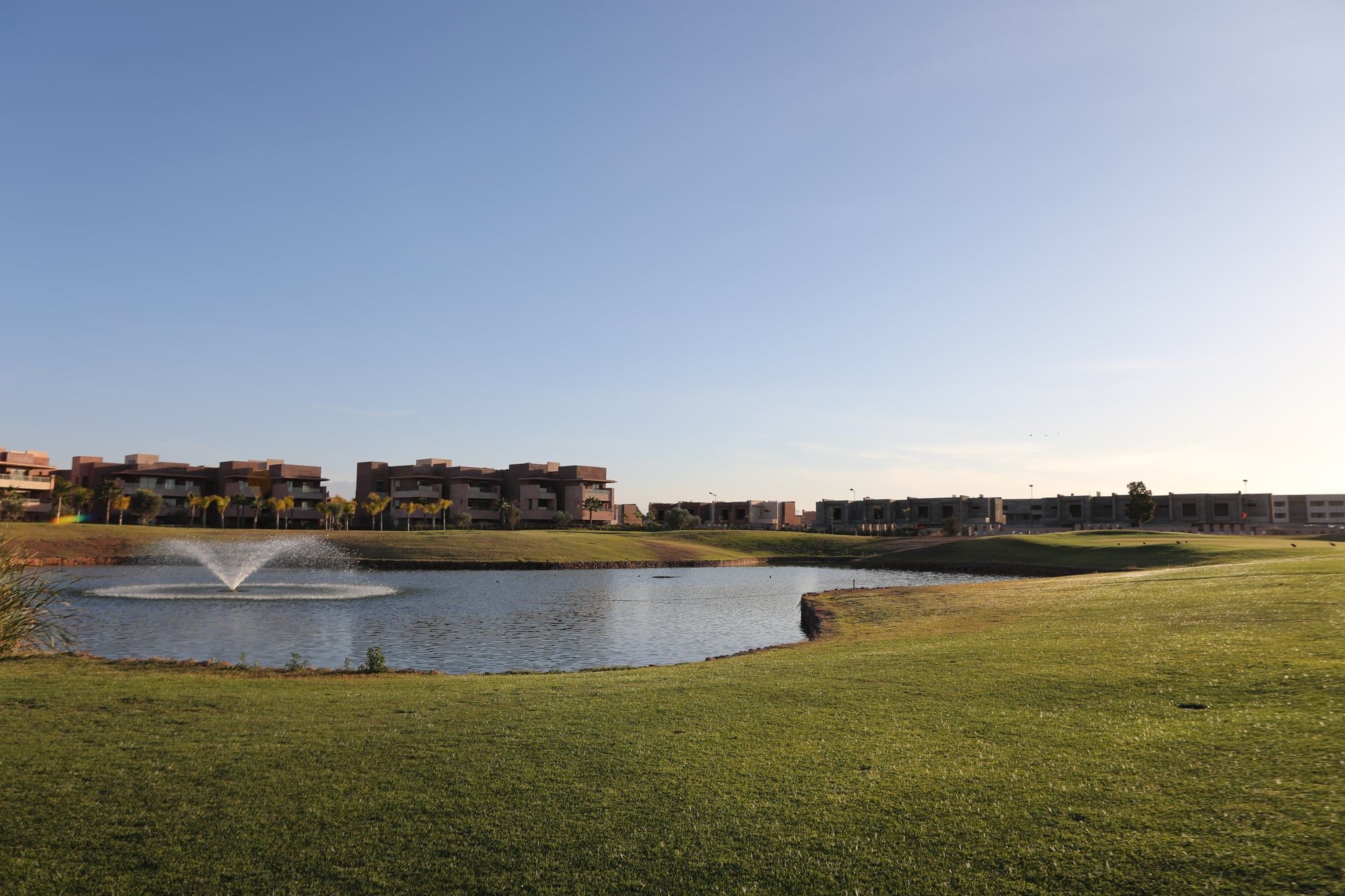 Residences overlooking a golf course lake in Marrakech