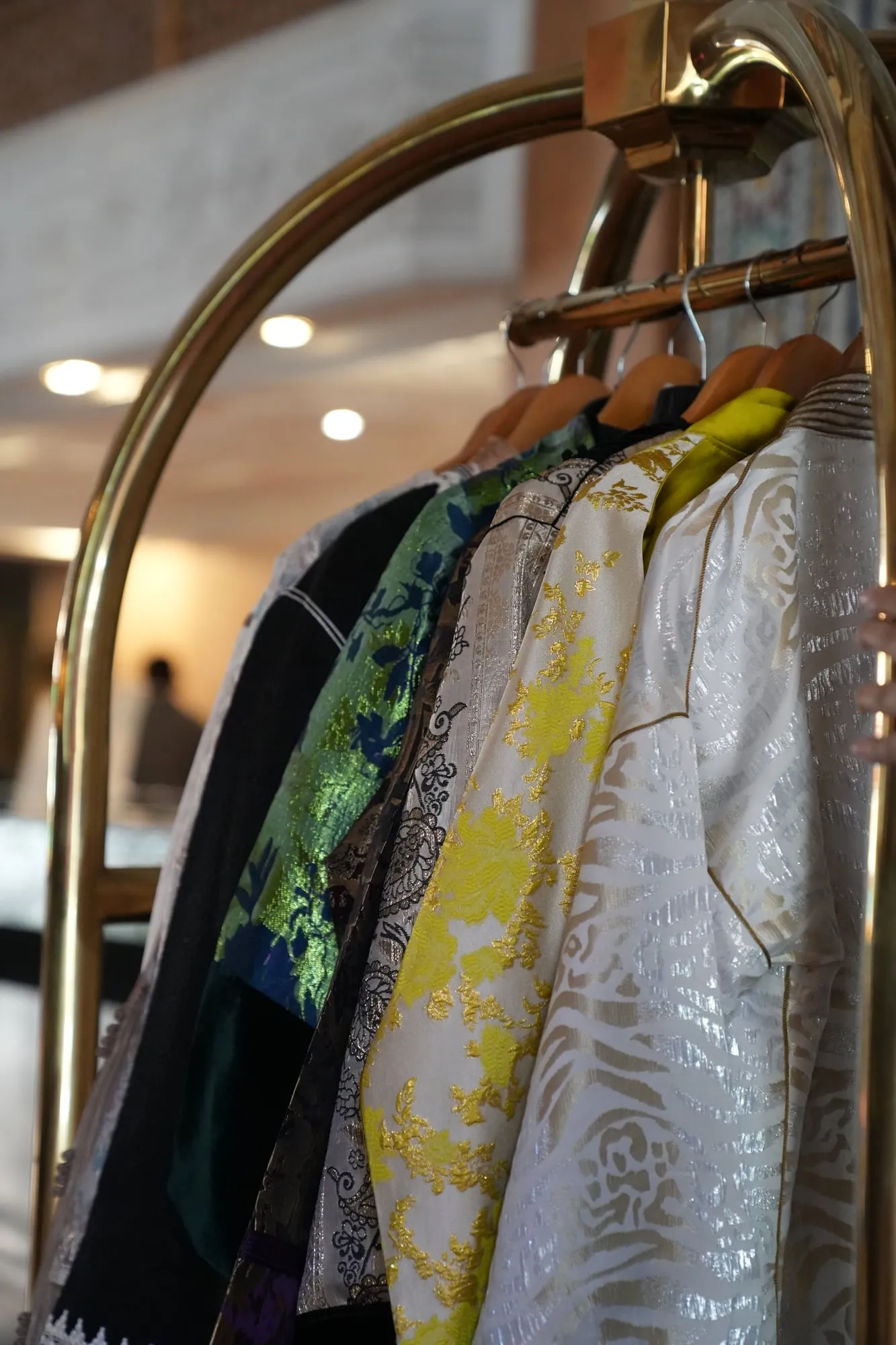 Caftans sur un portant d’hôtel, prêts pour un shooting photo à Marrakech