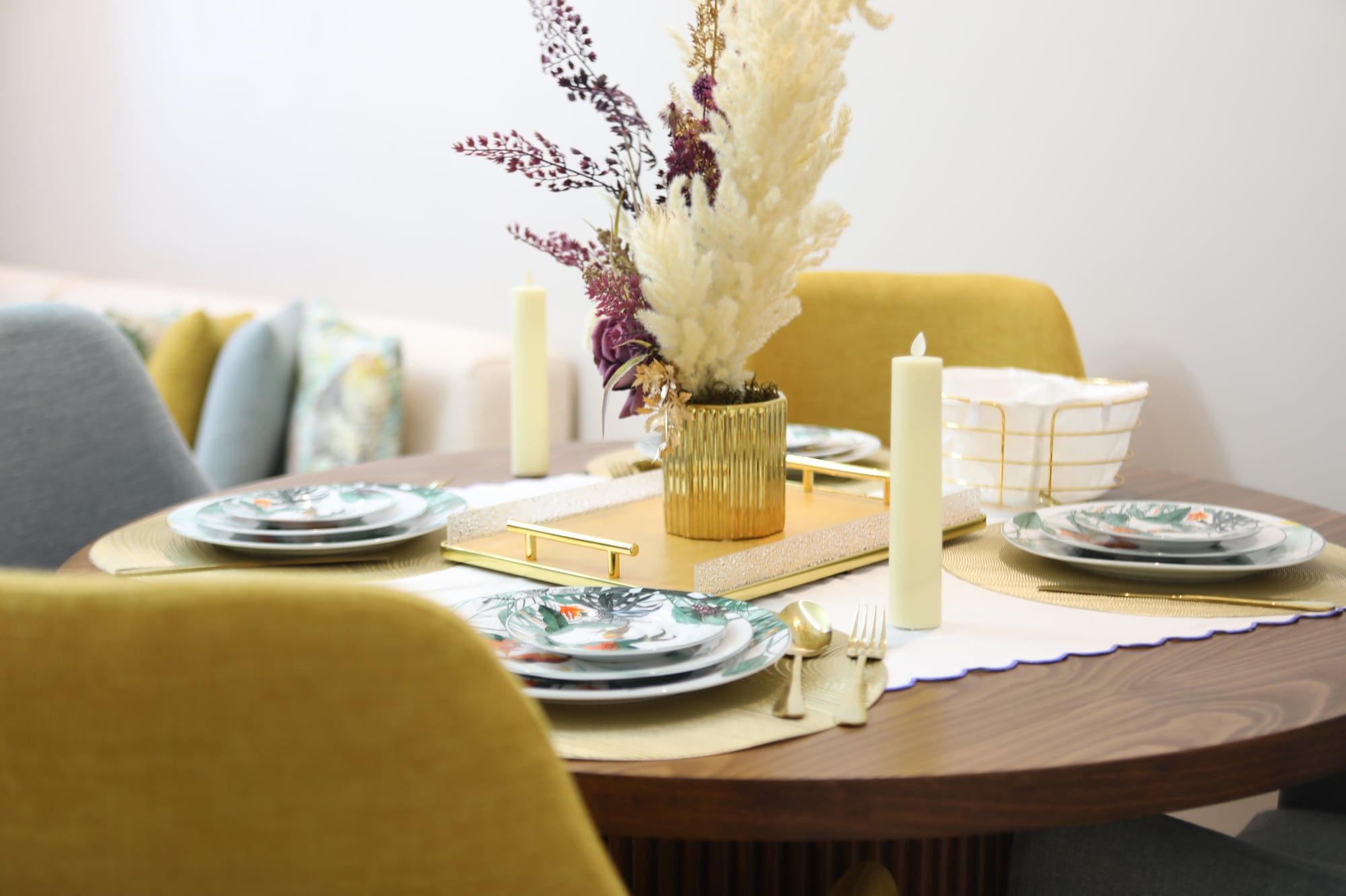 Restaurant table styled with ceramics, candles and dried flowers