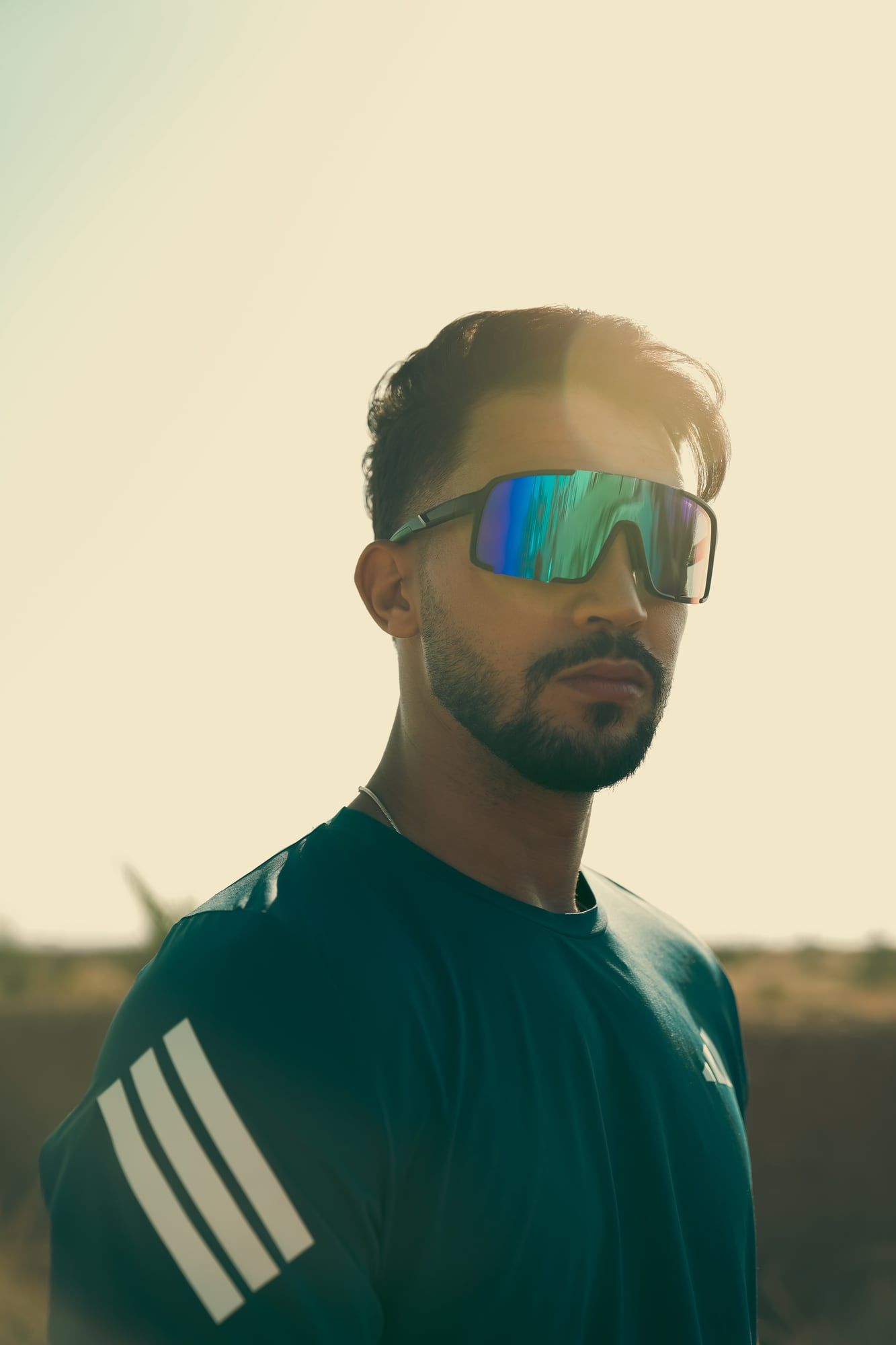 Athlete in sports sunglasses for a desert campaign