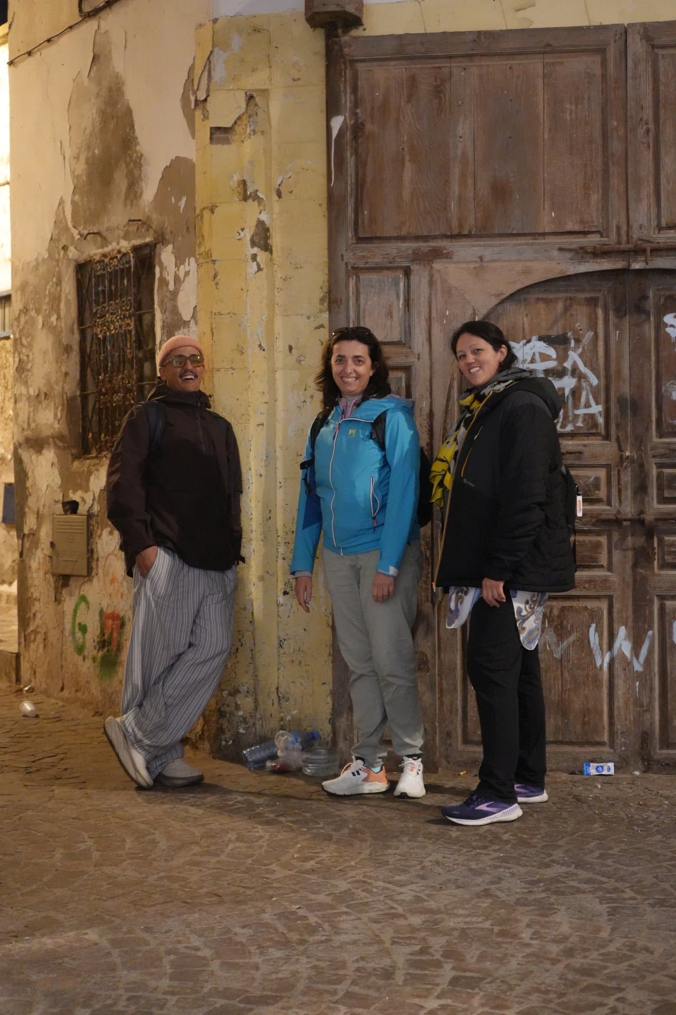 Travellers exploring the old medina of Marrakech with a guide