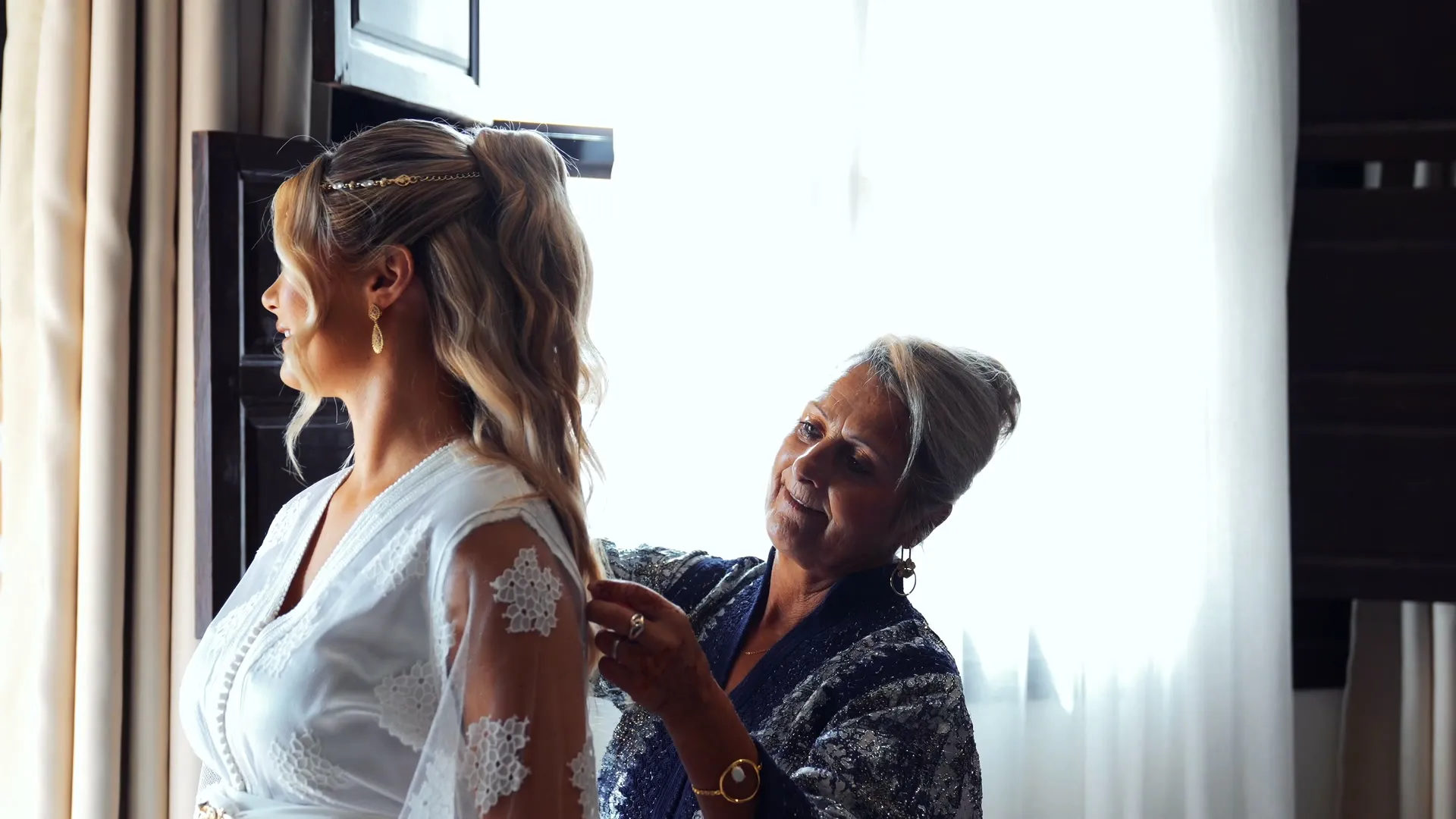 Bride getting ready with a relative on her wedding day in Marrakech